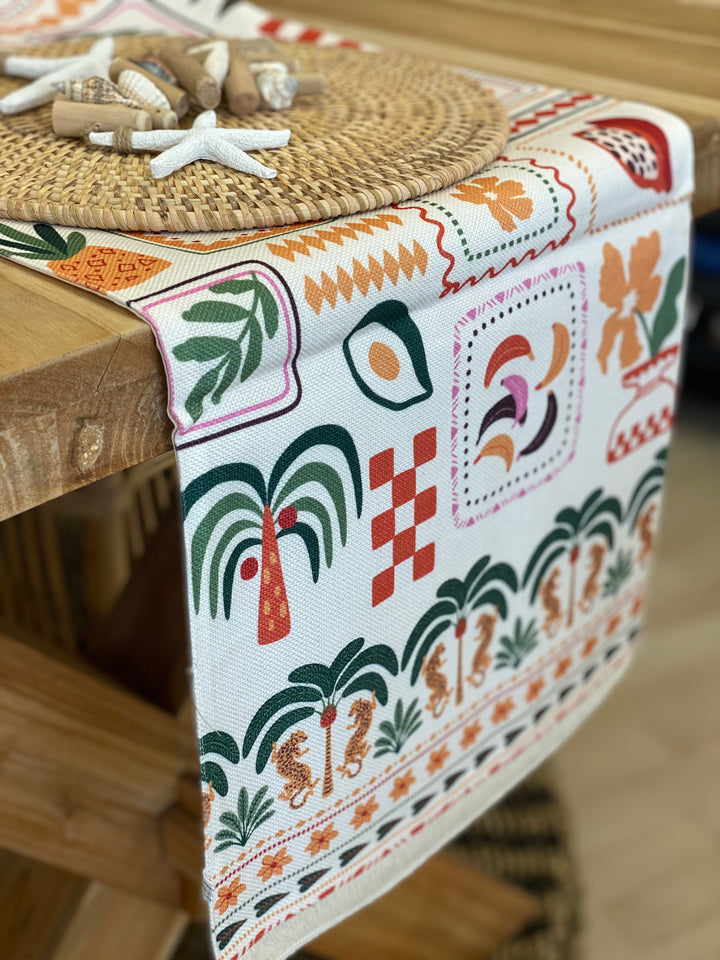 Decorative table runner with tropical patterns.