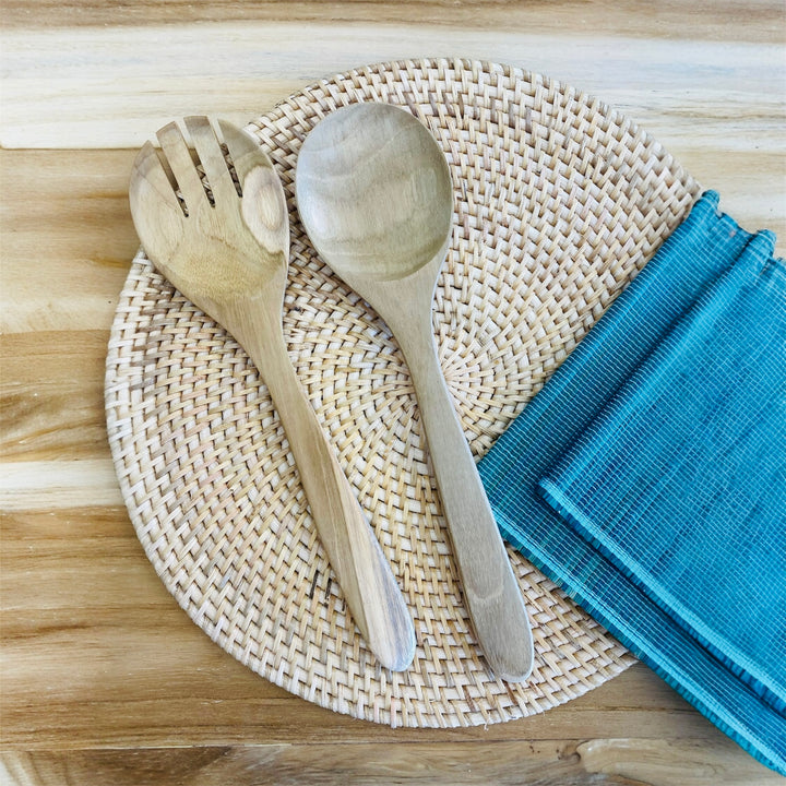 salad servers on a natural rattan placemat
