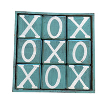 Wooden blocks with 'X' and 'O' pattern on a teal background