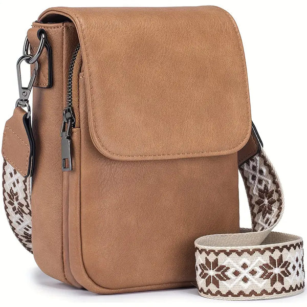 Tan foldover crossbody bag with front zip pocket and patterned adjustable strap