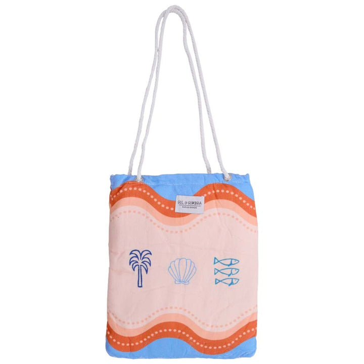 Colorful Mediterranean beach towel folded neatly into built-in bag, blue and pink tropical-inspired design, lightweight and travel-friendly microfibre.