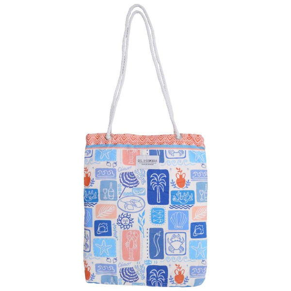 Colourful microfibre beach towel folded neatly into its built-in bag with blue and pink tropical palm tree and beach umbrella design, lightweight and travel-friendly