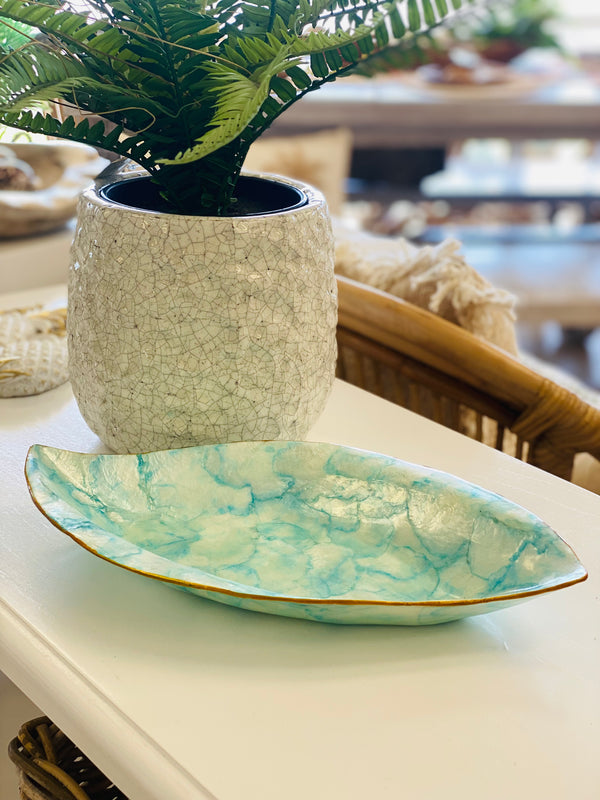 Decorative shell bowl with seafood marbled pattern on a white surface