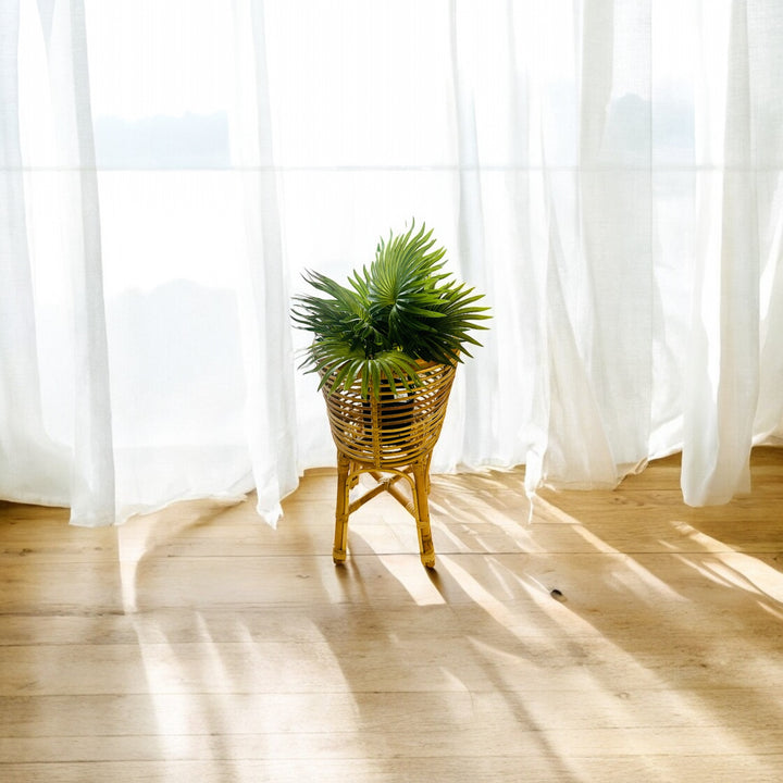  rattan planter in different sizes, one smaller and one larger, both with a cylindrical shape and open weave design.