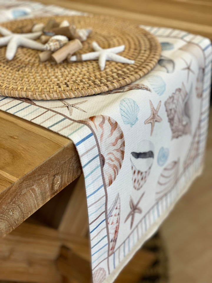 Coastal table runner with shell and starfish printing soft seaside colours, with fringe ends