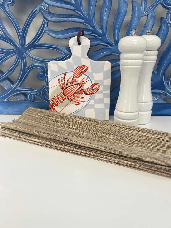 decorative trivet with lobster/crayfish print in vibrant red with pastel blue background