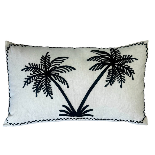 Minimalist cream cushion with hand-stitched black palm trees, perfect for sofas, chairs, or beds