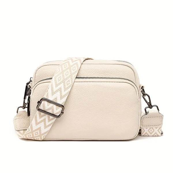 Beige crossbody bag with a patterned strap