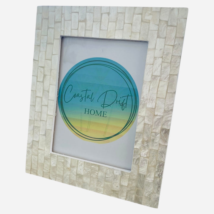 Decorative picture frame with 'Coastal Drift Home' logo on a white background