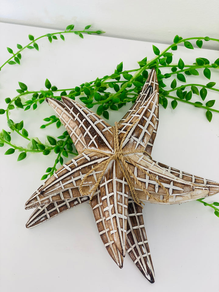 Decorative starfish with green leaves on a white background