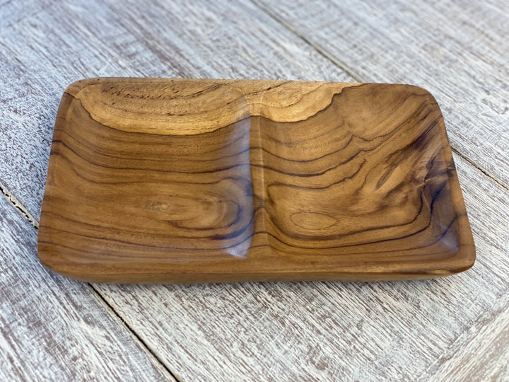 Wooden tray with a natural grain pattern on a light wooden surface