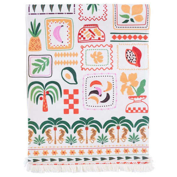 Colorful patterned table runner with tropical designs on a white background