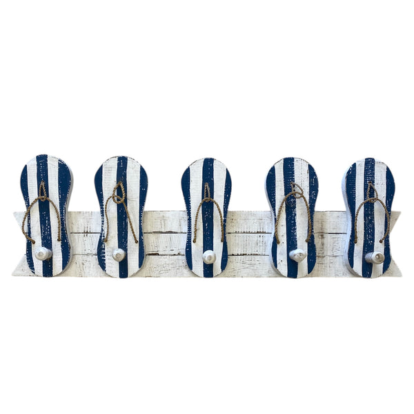 Set of five blue and white striped flip-flop hooks on a wooden board with a white background