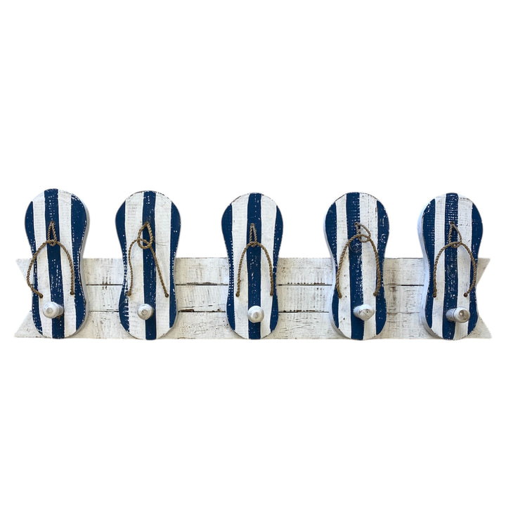 Set of five blue and white striped flip-flop hooks on a wooden board with a white background