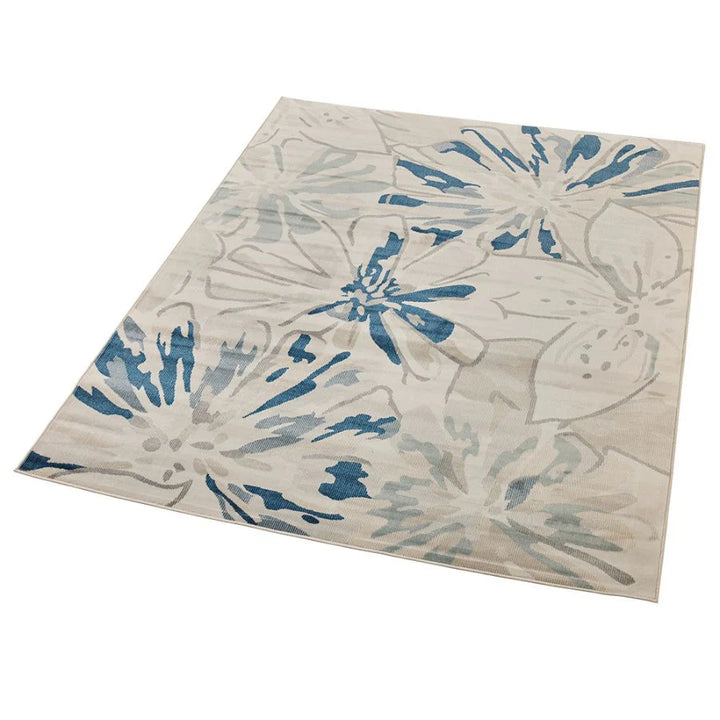 Floral patterned rug with blue and beige colors on a white background