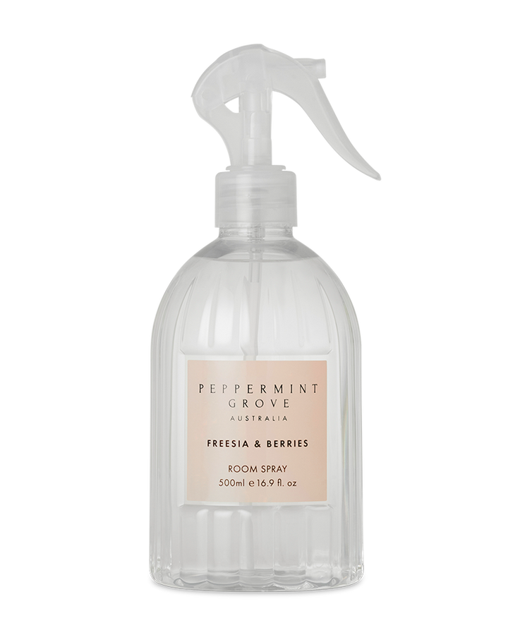 Clear room spray bottle with a label on a white background