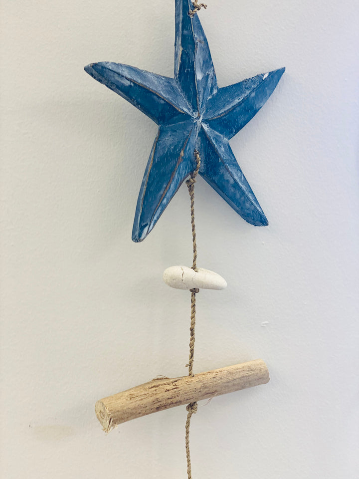 Decorative hanging star with driftwood on a white background
