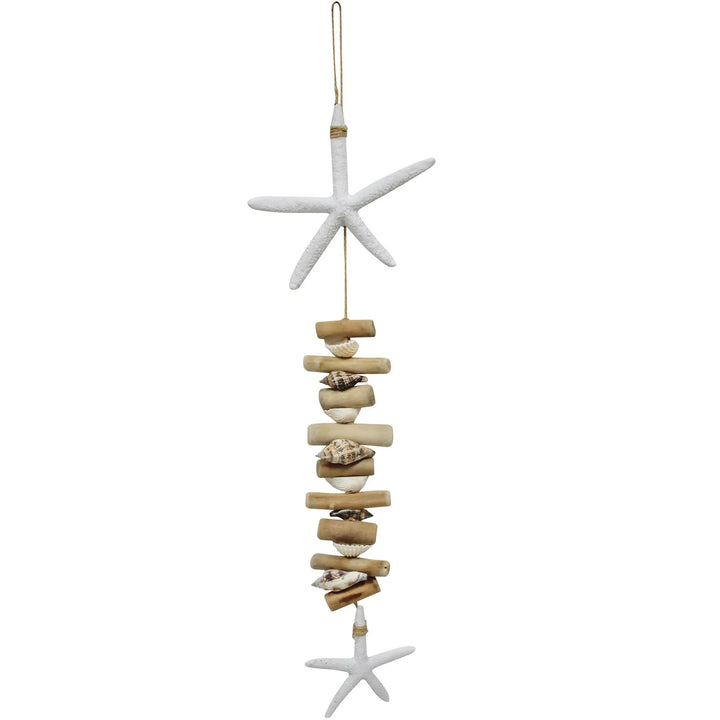 A hanging decoration made of driftwood and starfish with a white starfish at the top and bottom, connected by strings.