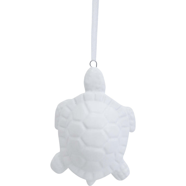 White turtle-shaped ornament hanging on a white background