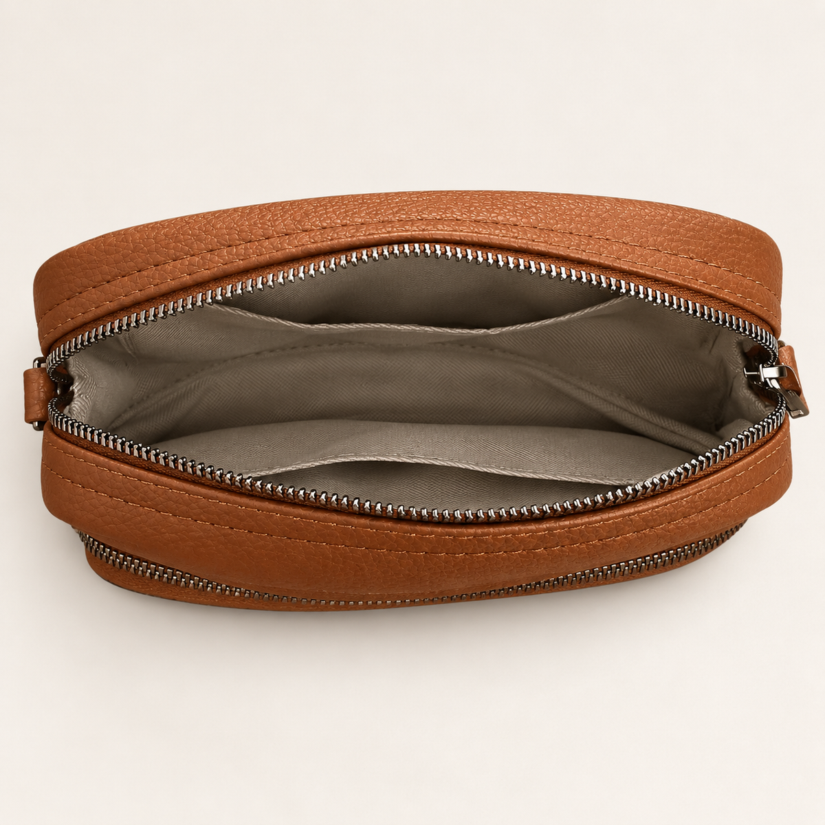 Inside the main zip compartment of a brown Kyla crossbody bag