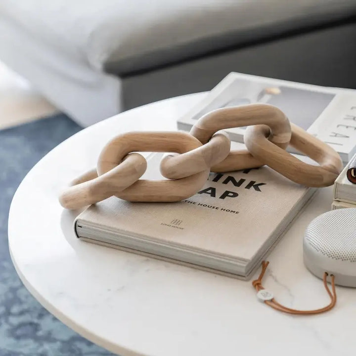 Wooden chain on a book on a marble surface