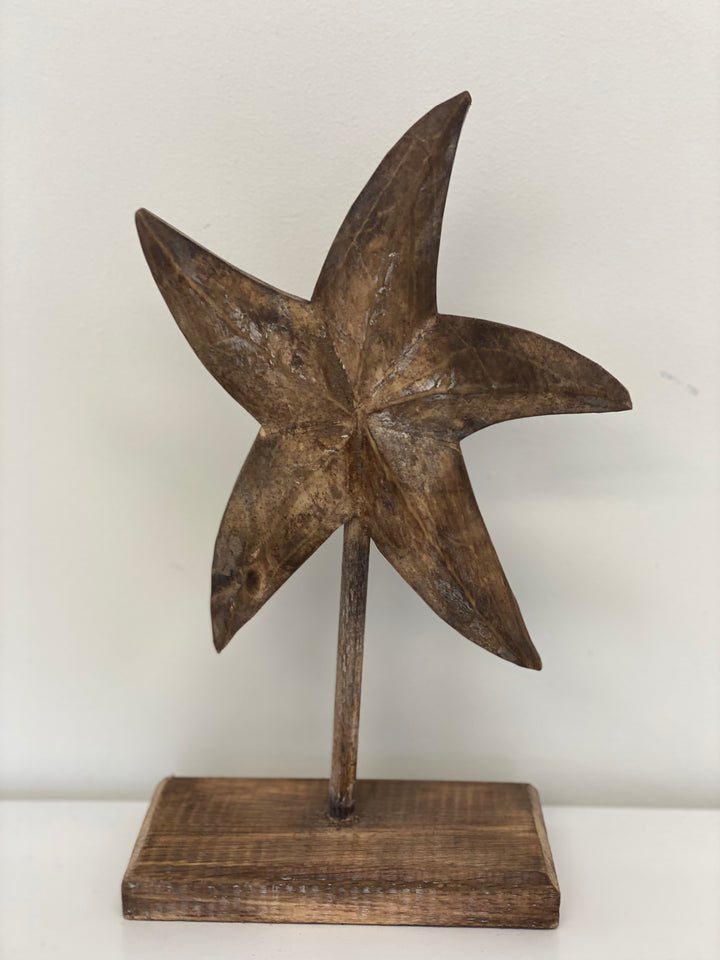 Natural wooden starfish sculpture on stand