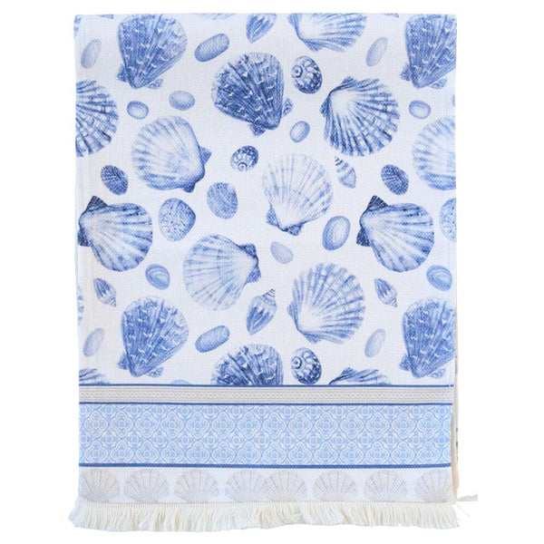 Coastal table runner with navy blue seashell motif on a crisp white background, featuring decorative border and fringe detail, perfect for Hamptons or beach house styling