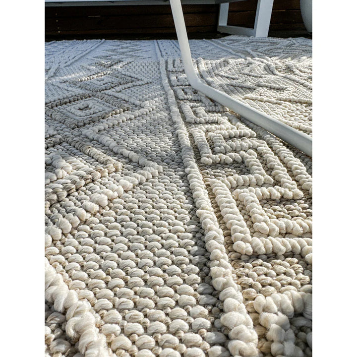 Textured rug with geometric pattern on a white background