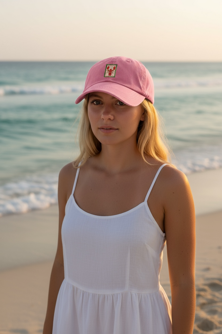 Ladies pink cap with a red lobster motif on the front. A great gift or wardrobe staple