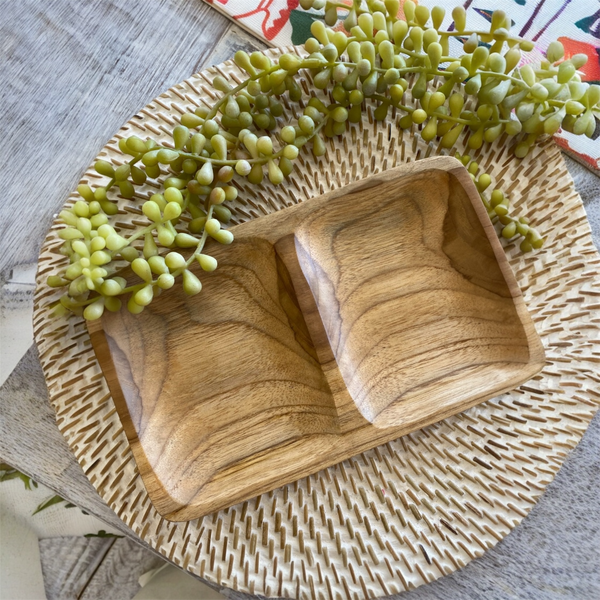 Wooden tray with two compartments on a textured surface with greenery