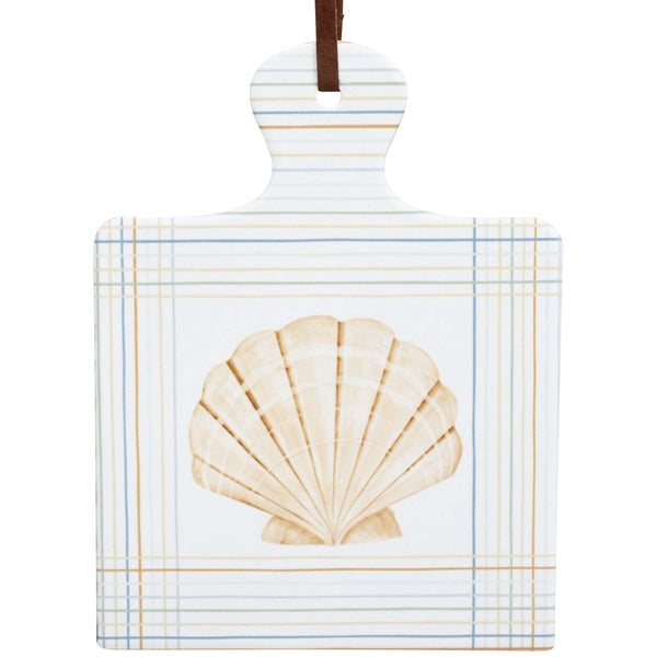 Decorative ceramic trivet with a shell design on a white background