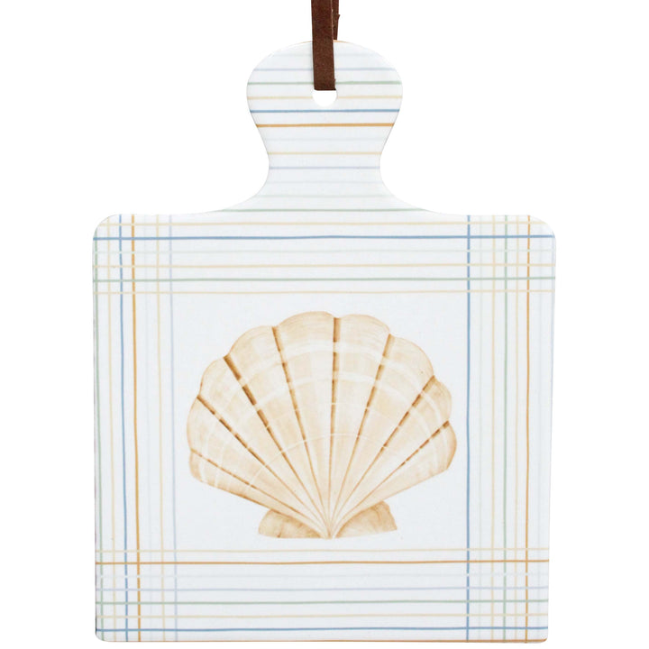 Decorative ceramic trivet with a shell design on a white background