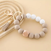 Modern keyring made with soft beige and taupe silicone beads