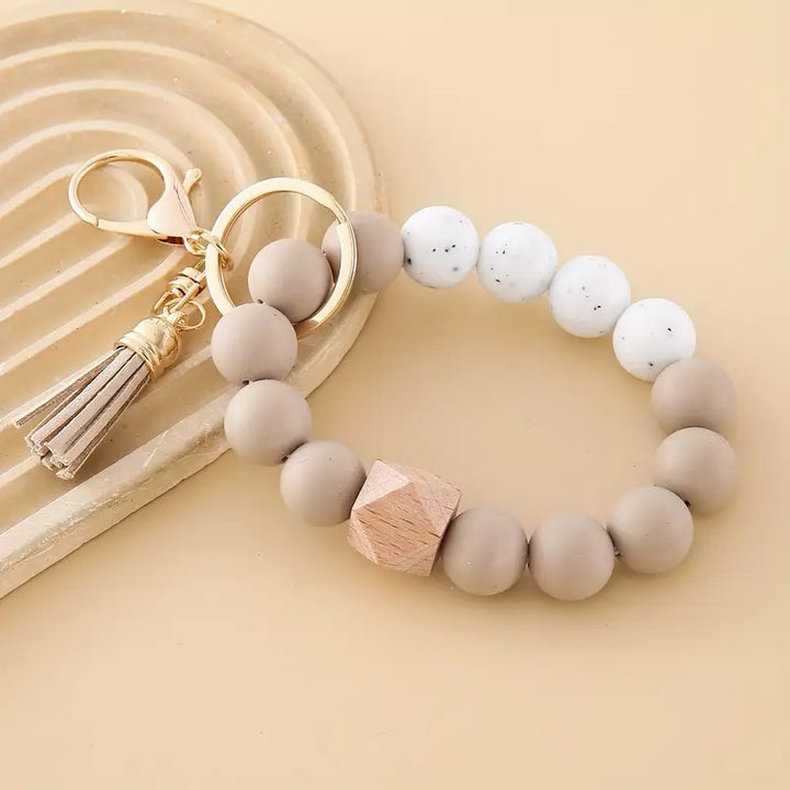 Modern keyring made with soft beige and taupe silicone beads