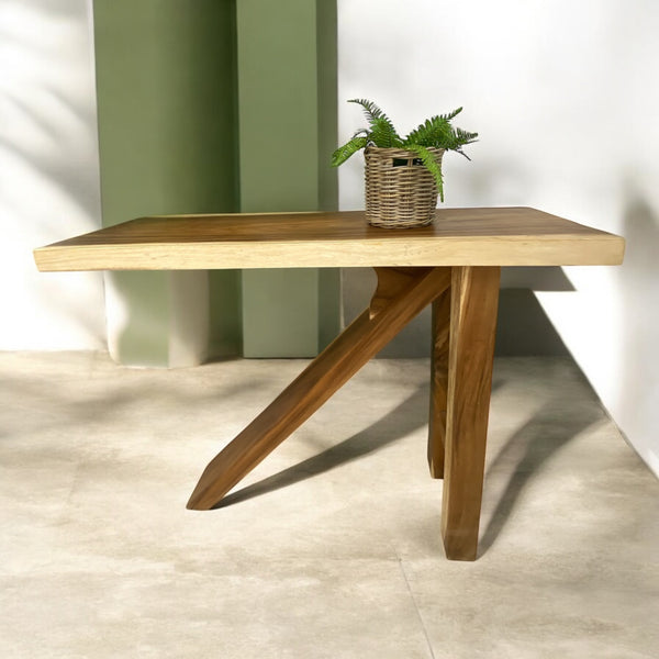 A free-standing wooden Z Bar table suitable for indoor or outdoor spaces, with a plant vase on top.