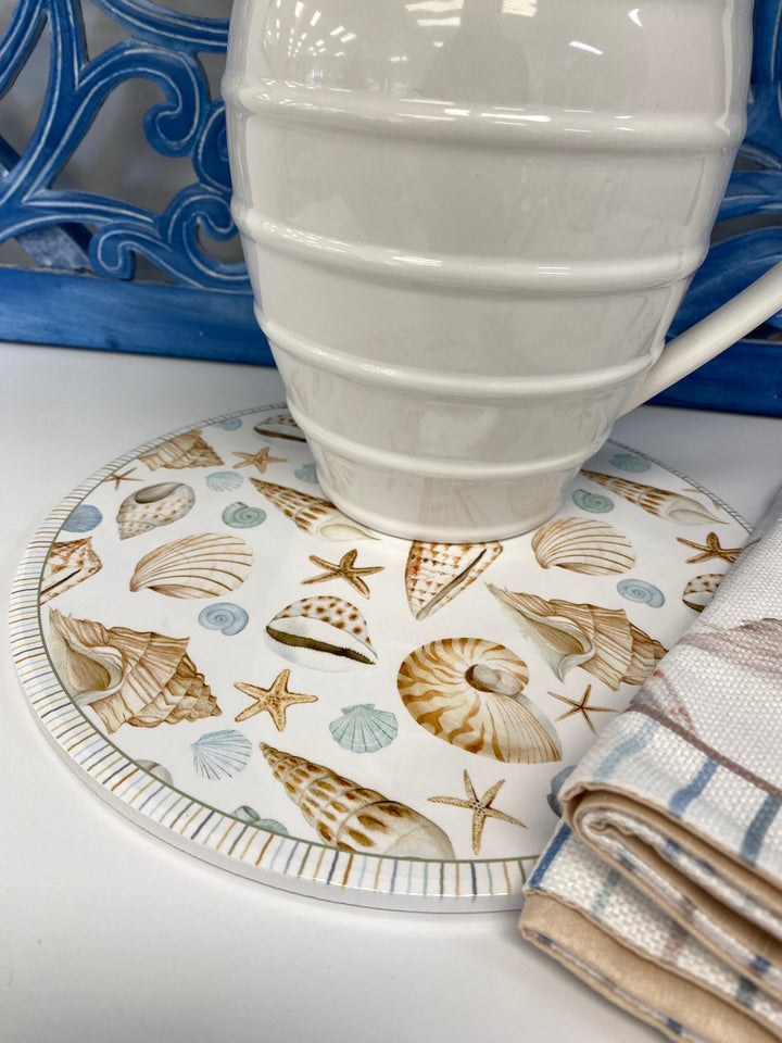 Round beach trivet or placemat with shell and starfish pattern on a white background