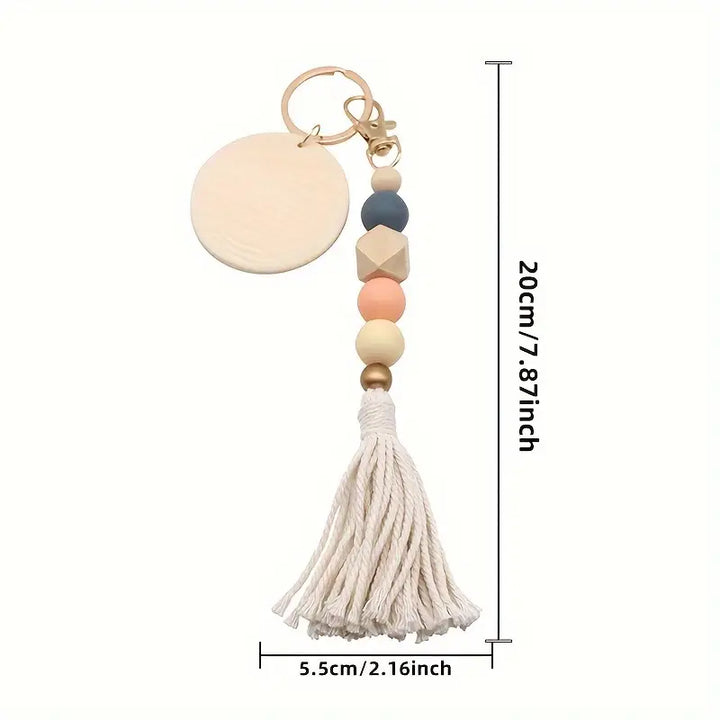 Keychain with beads and tassel, shown with measurements on a white background