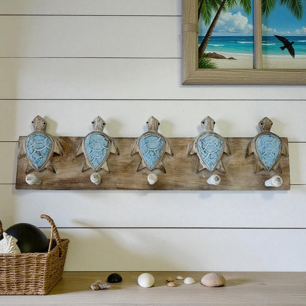 decorative but practical, these timber wall hooks featuring hand carved turtles in a blue finish are the perfect addition to any coastal home or beach house