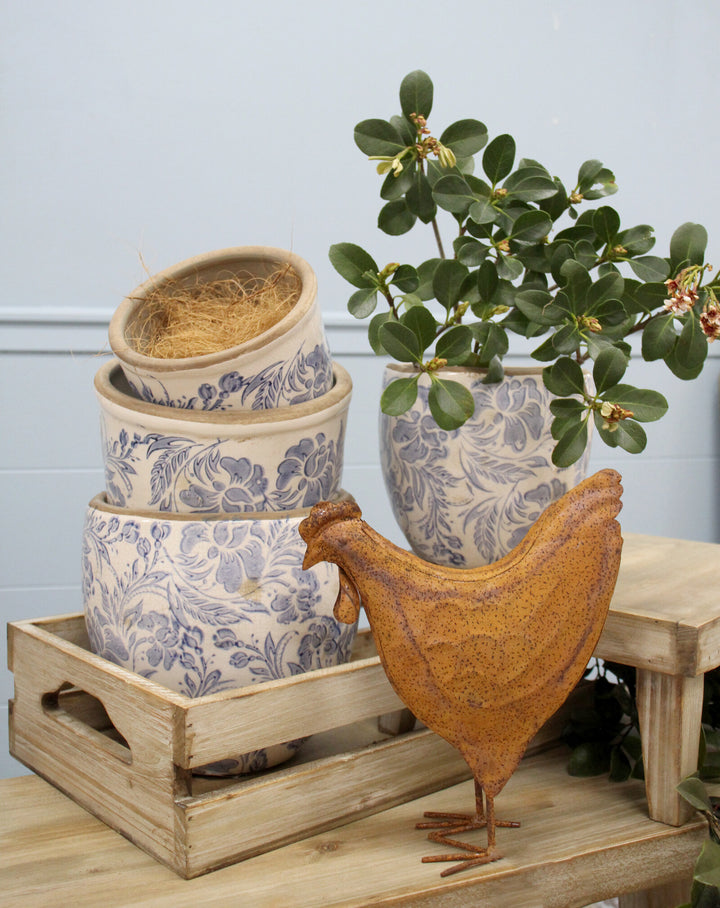 Vintage blue and white ceramic planter with crackle glaze and ornate print, perfect for displaying indoor plants or flowers