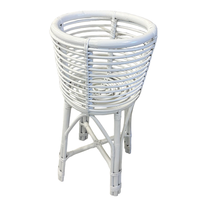 A cylindrical white rattan planter with a stand suitable for indoor or outdoor use.