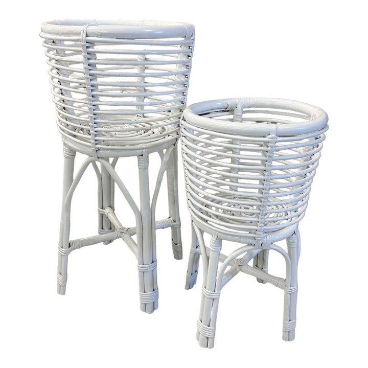 Two rattan planters in different sizes, one smaller and one larger, both with a cylindrical shape and open weave design.