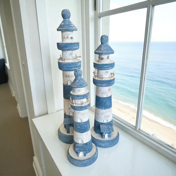 Timber lighthouse decor pieces available in 3 sizes. Featuring a navy and white stripe, they are the perfect compliment to any coastal themed space or home