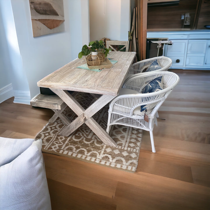 white cane dining chair at a white wash x leg dining table