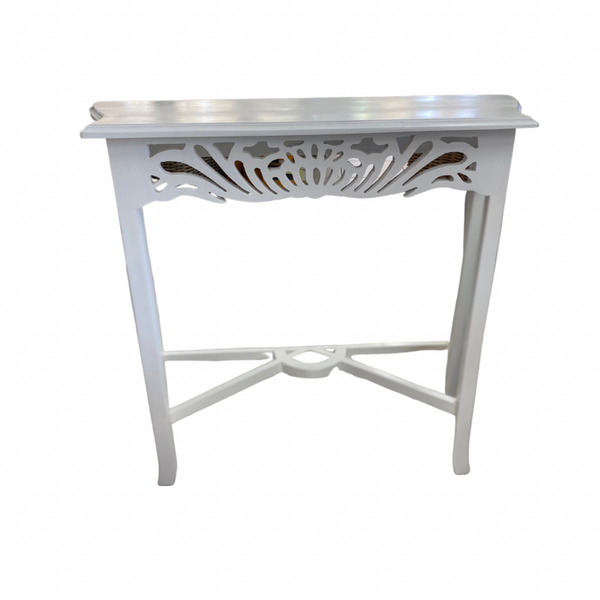 A compact white Semarang hall table with carved front design, made of mahogany timber, with a rectangular tabletop and a decorative leg base.