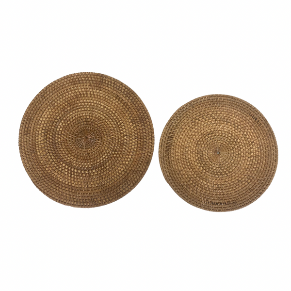 Two round rattan placemats, one larger than the other, with a brown color tone.