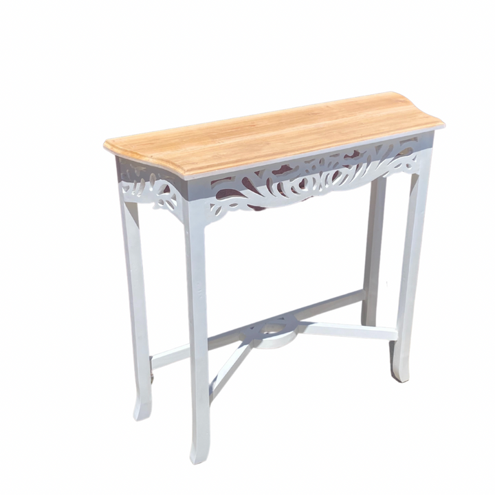 A compact white Semarang hall table with carved front design, made of mahogany timber, with a rectangular tabletop and a decorative leg base.